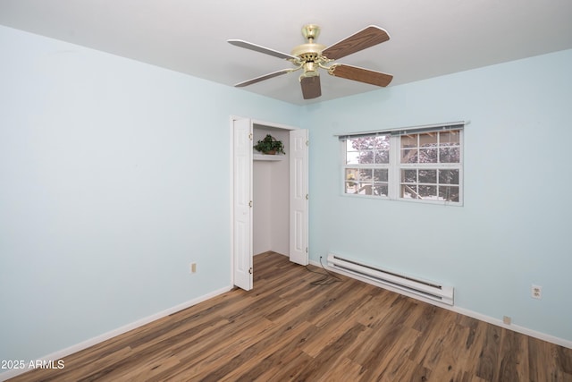 3098 N Starlight Dr, Prescott Valley, AZ 86314 - unfurnished bedroom with a baseboard heating unit, wood finished floors, a closet, baseboards, and a ceiling fan