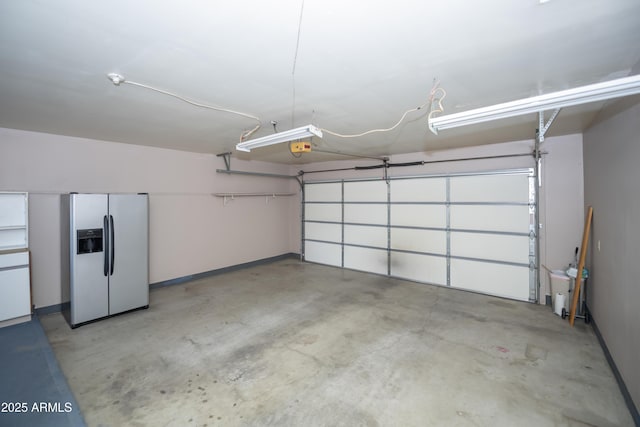 3098 N Starlight Dr, Prescott Valley, AZ 86314 - garage with stainless steel refrigerator with ice dispenser, baseboards, and a garage door opener