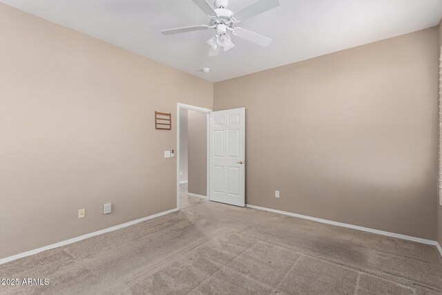 empty room featuring ceiling fan and light colored carpet