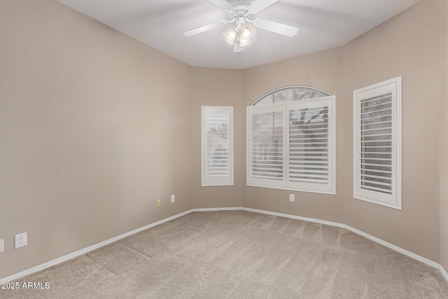 carpeted spare room with ceiling fan