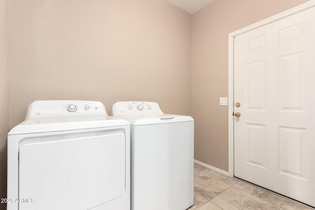 laundry room with washing machine and clothes dryer