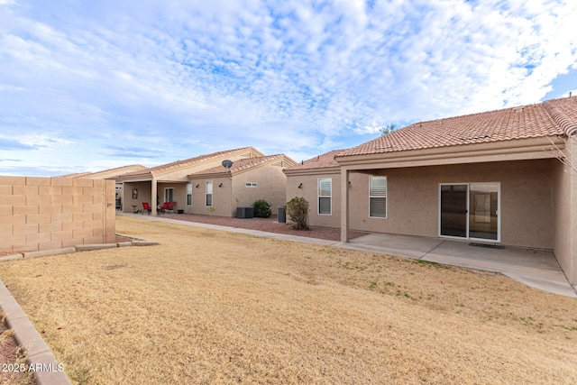 back of property with central AC unit and a patio area