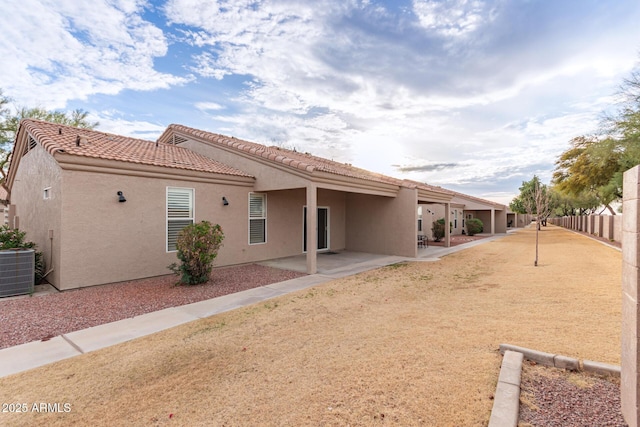 rear view of property with a patio area and central air condition unit