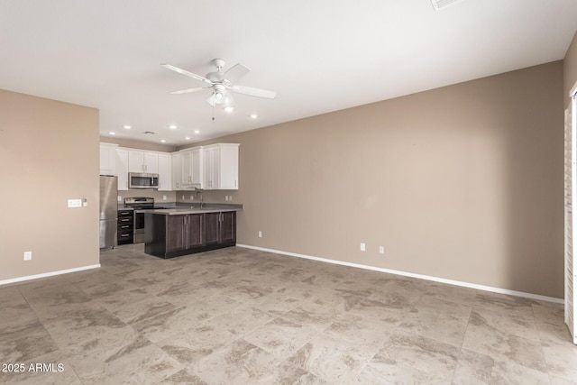 kitchen featuring stainless steel appliances, white cabinetry, dark brown cabinets, and ceiling fan