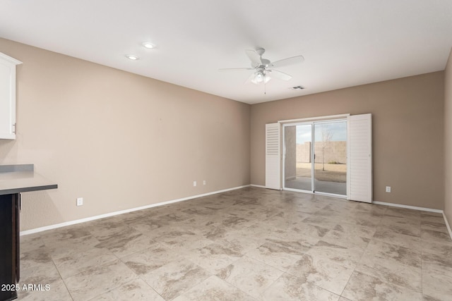 spare room with ceiling fan