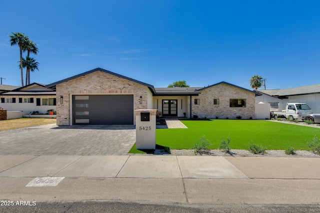 ranch-style house with brick siding, a front lawn, and an attached garage