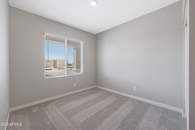 spare room with carpet and baseboards