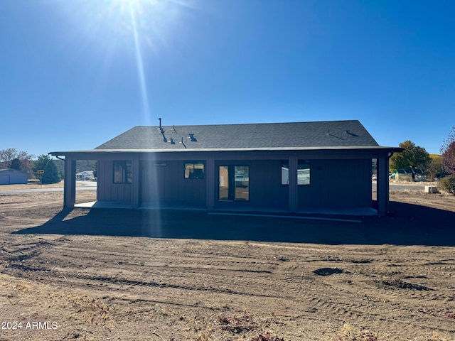 back of house featuring a carport