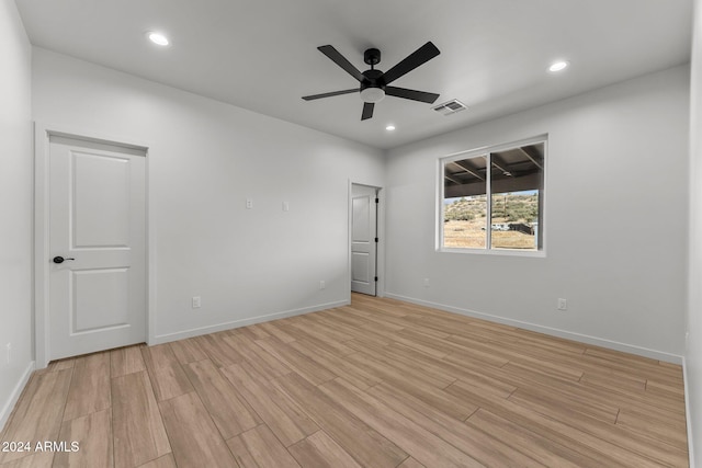 spare room with light hardwood / wood-style flooring and ceiling fan