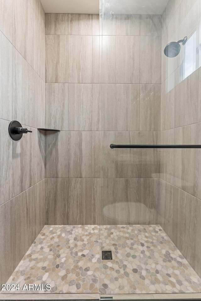 bathroom with tiled shower