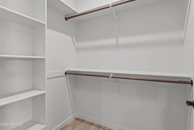 walk in closet featuring light hardwood / wood-style floors