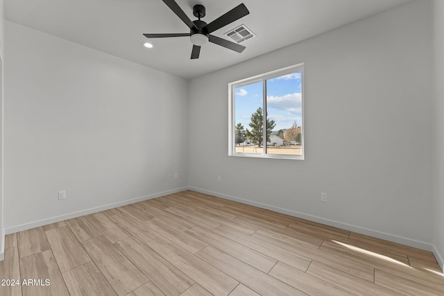 spare room featuring ceiling fan and light hardwood / wood-style flooring