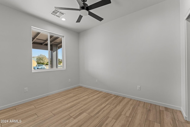 spare room with ceiling fan and light hardwood / wood-style flooring