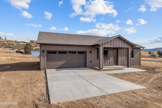 view of front of property with a mountain view and a garage