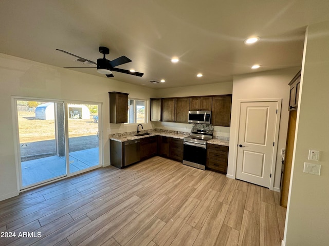 kitchen with dark brown cabinets, sink, appliances with stainless steel finishes, and light hardwood / wood-style flooring