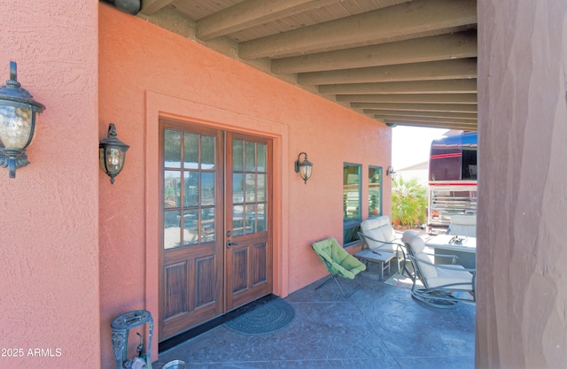 entrance to property with stucco siding and french doors