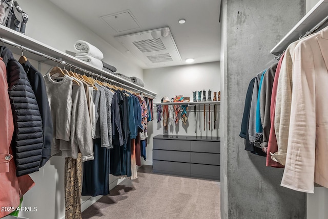 walk in closet featuring light colored carpet