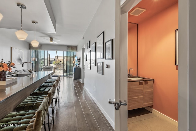 hallway with sink and hardwood / wood-style floors