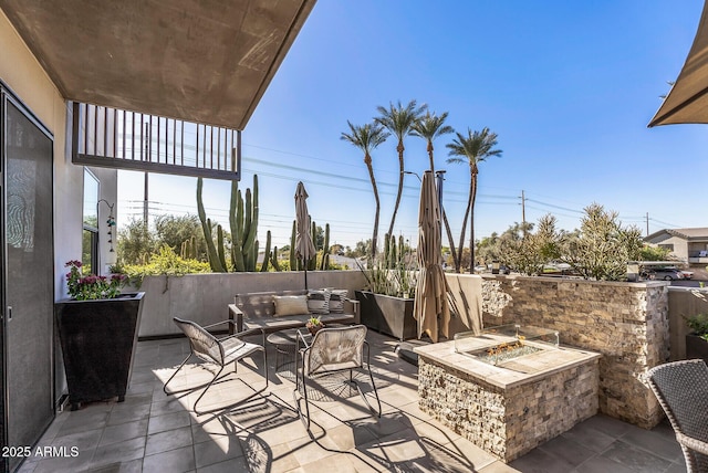 view of patio / terrace with an outdoor living space with a fire pit