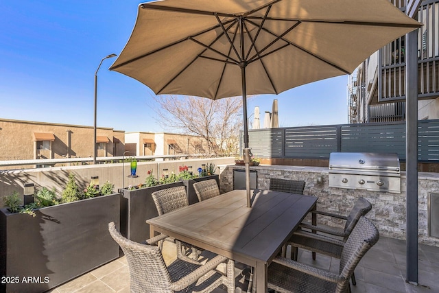 view of patio / terrace featuring a grill and an outdoor kitchen