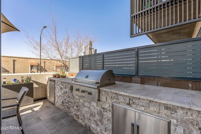 view of patio with an outdoor kitchen and area for grilling