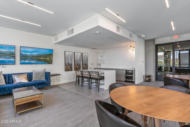 dining area with concrete flooring and beverage cooler