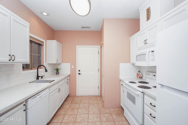 kitchen featuring light countertops, visible vents, white cabinetry, a sink, and white appliances