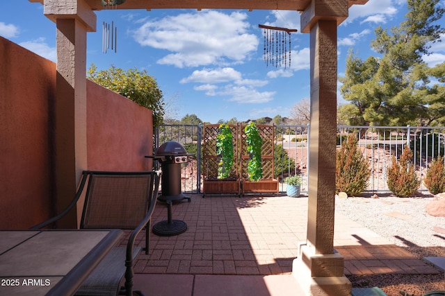 view of patio featuring fence and area for grilling