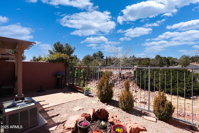 view of patio with central AC unit, grilling area, and fence