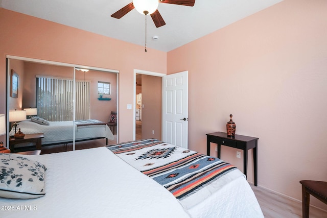 bedroom with ceiling fan, a closet, and light wood-style flooring