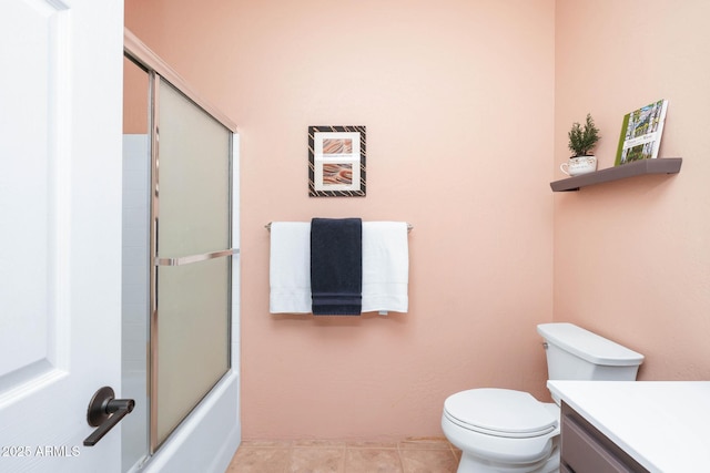 full bathroom featuring shower / bath combination with glass door, vanity, toilet, and tile patterned floors