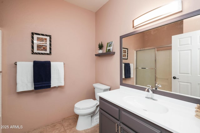 full bath with toilet, vanity, a shower with shower door, and tile patterned floors