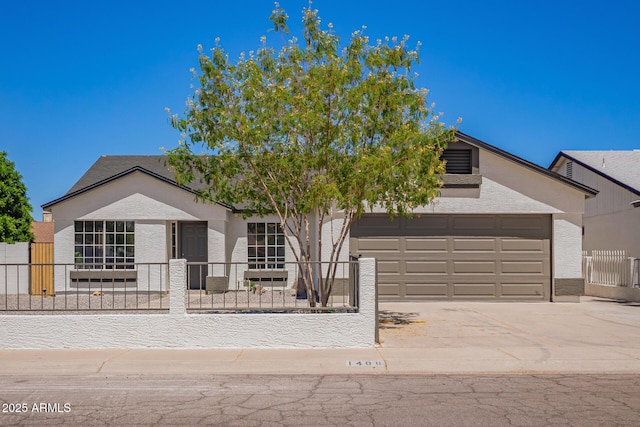 1408 E Carson Rd, Phoenix, AZ 85042 - view of front of property with a garage, a fenced front yard, stucco siding, and concrete driveway
