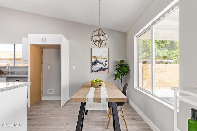 1408 E Carson Rd, Phoenix, AZ 85042 - dining space with an inviting chandelier, baseboards, vaulted ceiling, and light wood-style flooring