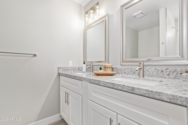1408 E Carson Rd, Phoenix, AZ 85042 - bathroom featuring double vanity, baseboards, and a sink