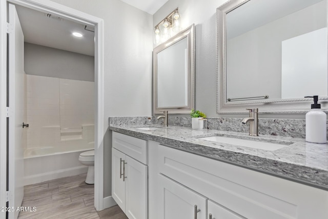 1408 E Carson Rd, Phoenix, AZ 85042 - full bathroom with double vanity, toilet, a sink, and wood finished floors