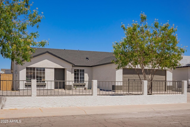 1408 E Carson Rd, Phoenix, AZ 85042 - view of front of house featuring an attached garage, a fenced front yard, and stucco siding