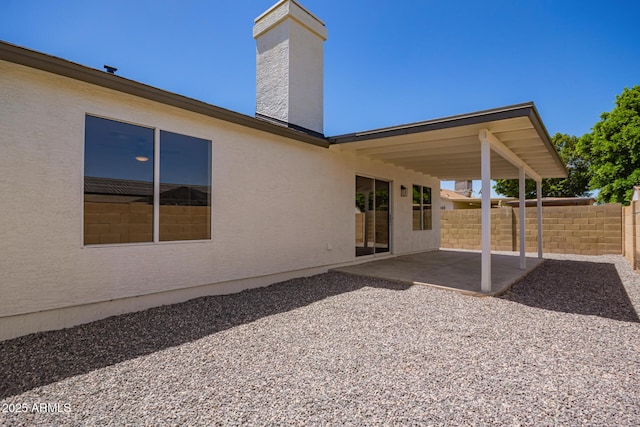 1408 E Carson Rd, Phoenix, AZ 85042 - back of property featuring fence, a chimney, a patio area, and stucco siding