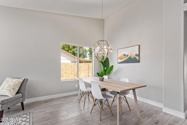 1408 E Carson Rd, Phoenix, AZ 85042 - dining space with baseboards, a towering ceiling, wood finished floors, and a notable chandelier