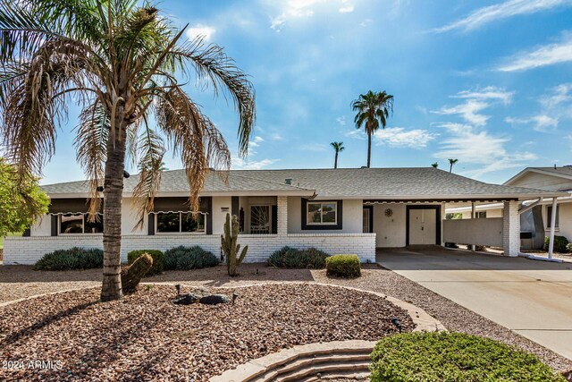 ranch-style home featuring a carport