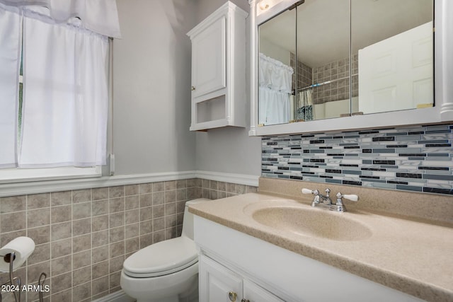 bathroom featuring vanity, tile walls, a shower with shower curtain, and toilet