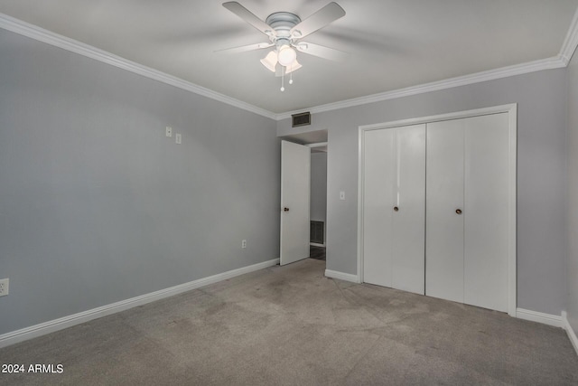 unfurnished bedroom featuring ceiling fan, a closet, ornamental molding, and light carpet