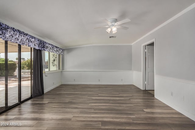 spare room with dark wood-type flooring, ceiling fan, and ornamental molding