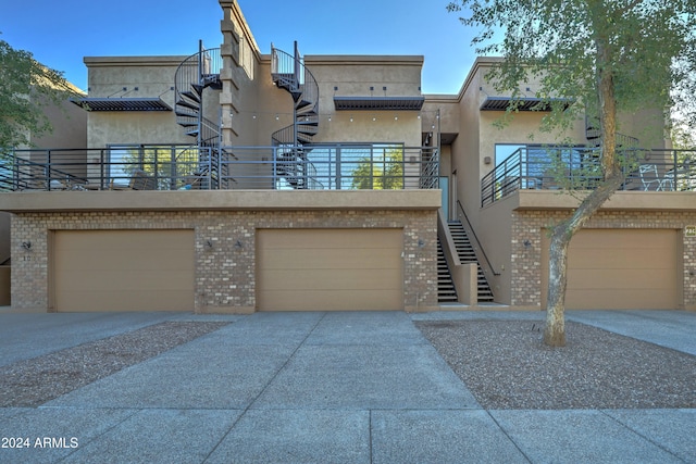 view of front facade with a garage and a balcony