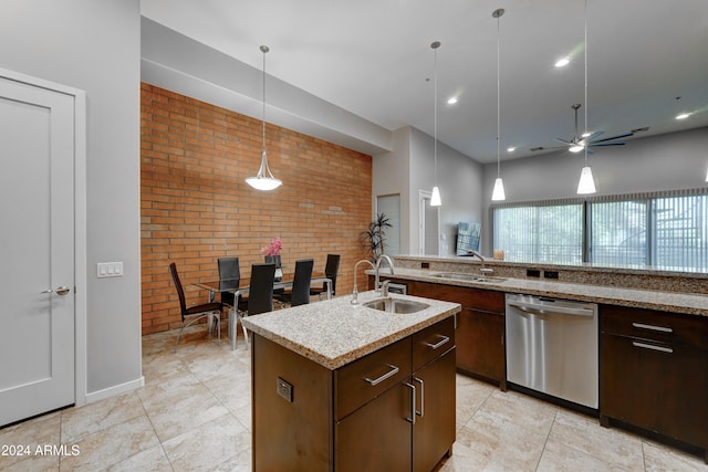 kitchen featuring ceiling fan, sink, stainless steel dishwasher, brick wall, and decorative light fixtures