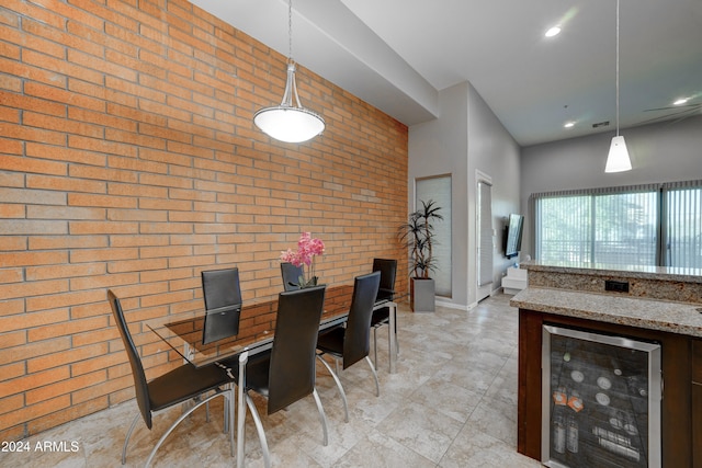 unfurnished dining area with brick wall and beverage cooler