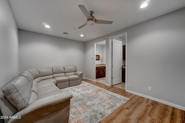 living room with ceiling fan and light wood-type flooring