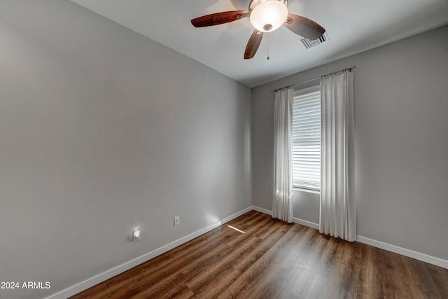 empty room with hardwood / wood-style floors and ceiling fan