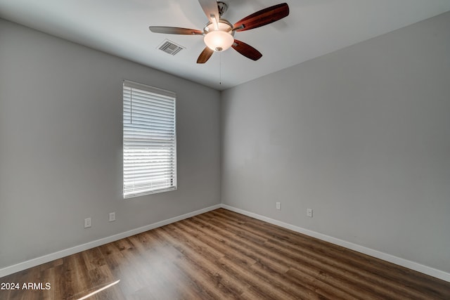 unfurnished room with ceiling fan and dark wood-type flooring