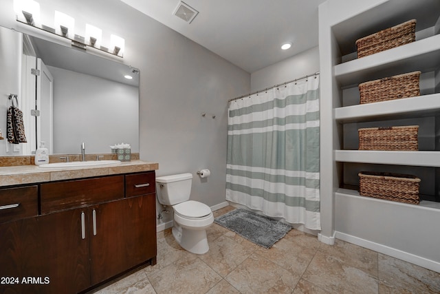 bathroom with walk in shower, vanity, and toilet